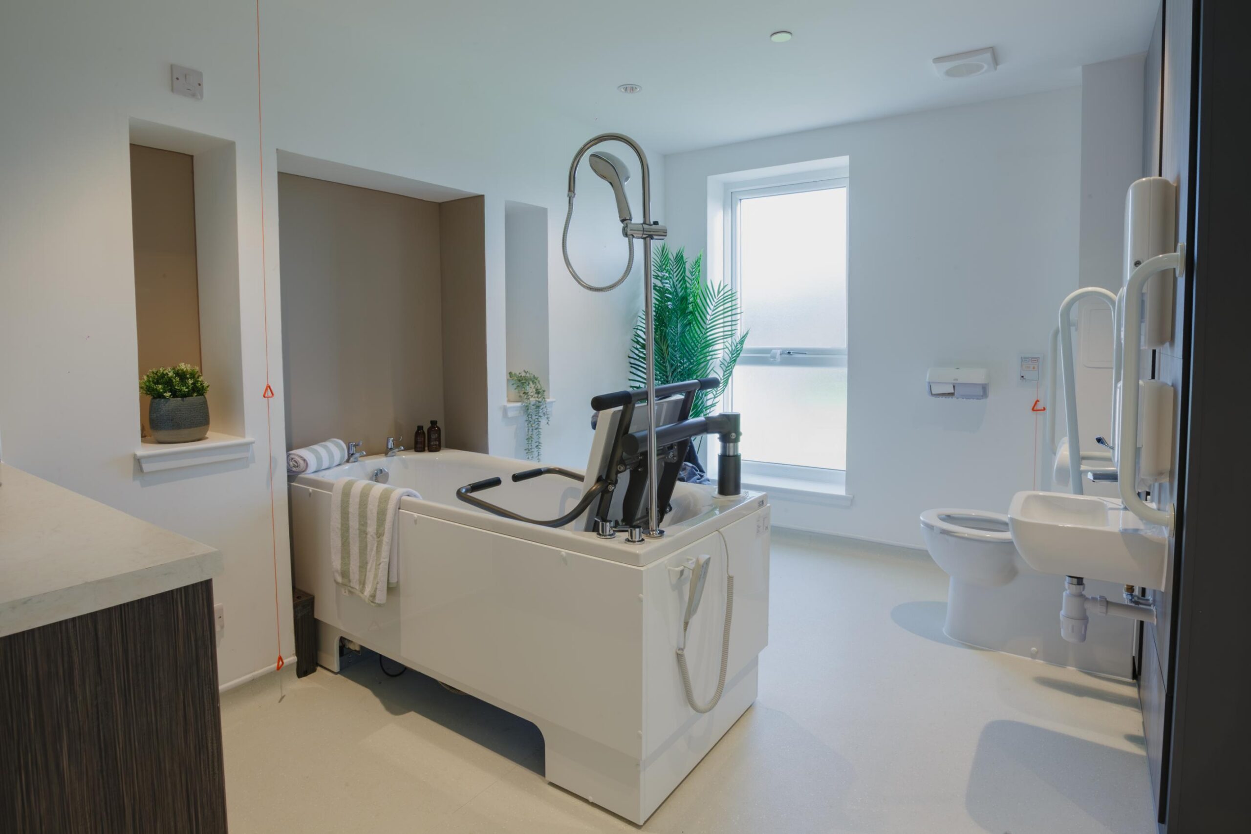 assisted bath in bright bathroom