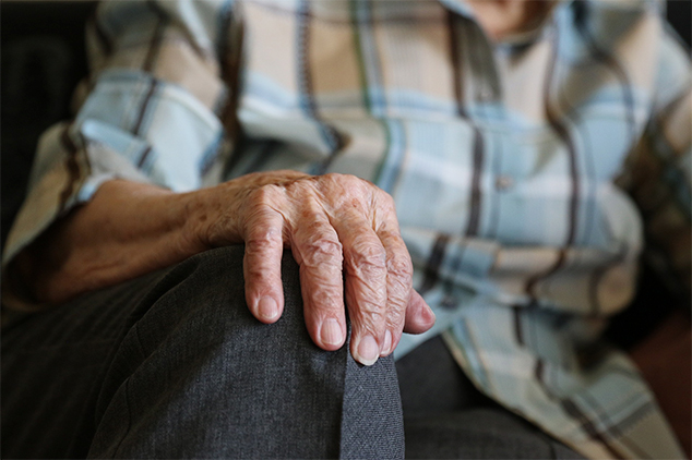 elderly man with hand on knee