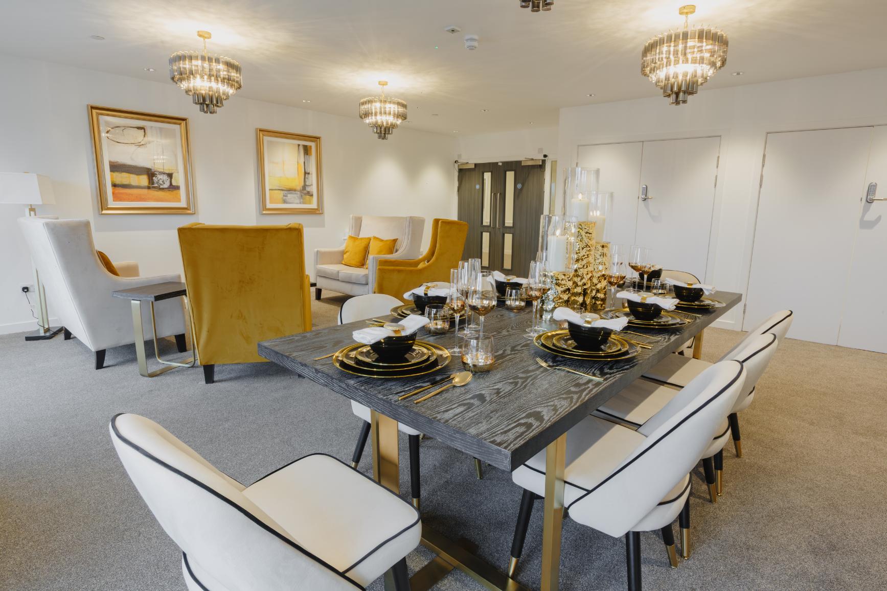 Black dining table set for meal with gold decorations