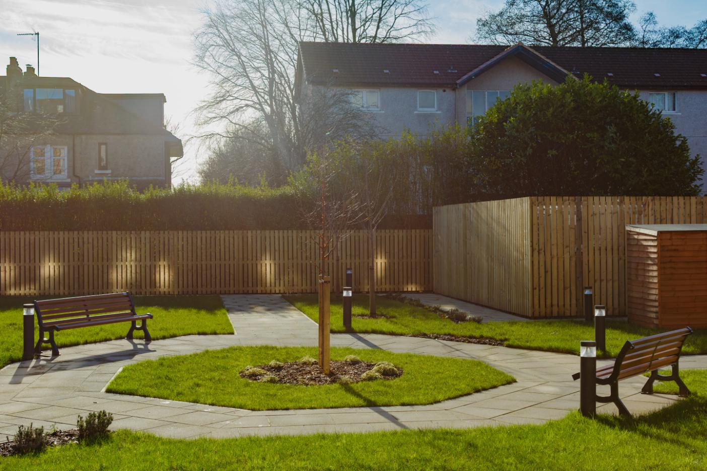 care home courtyard with paved pathways and benches