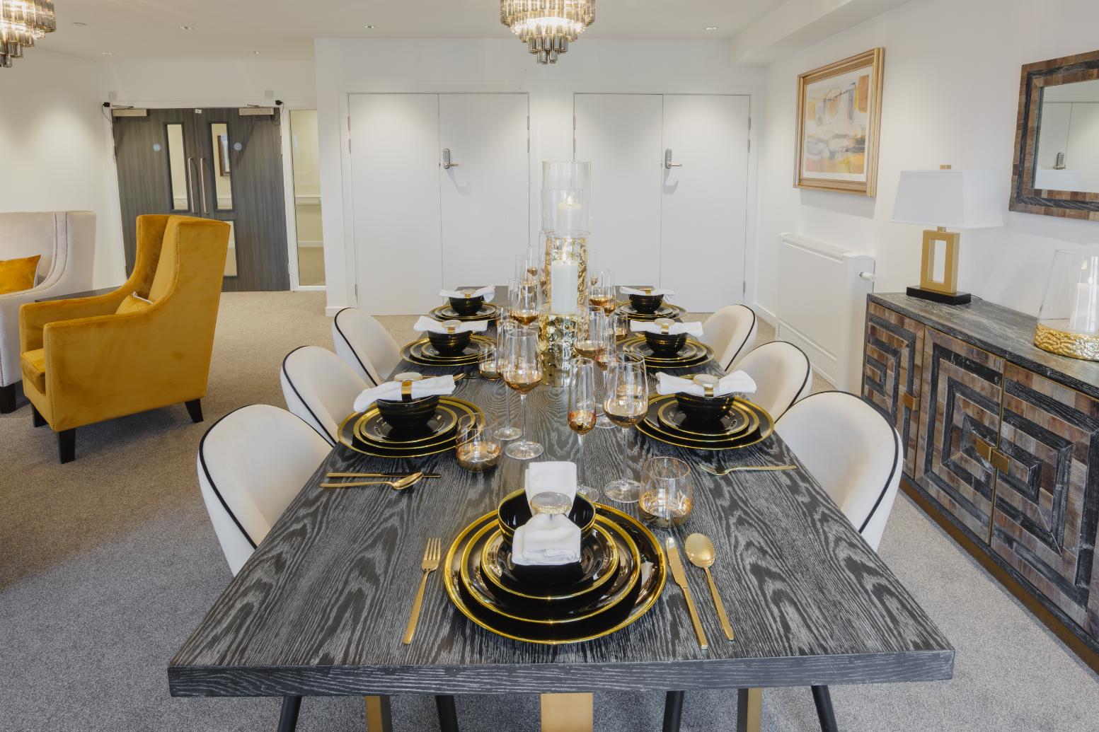 grey dining table set with gold cutlery and plates
