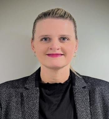 woman in black shirt and jacket smiling