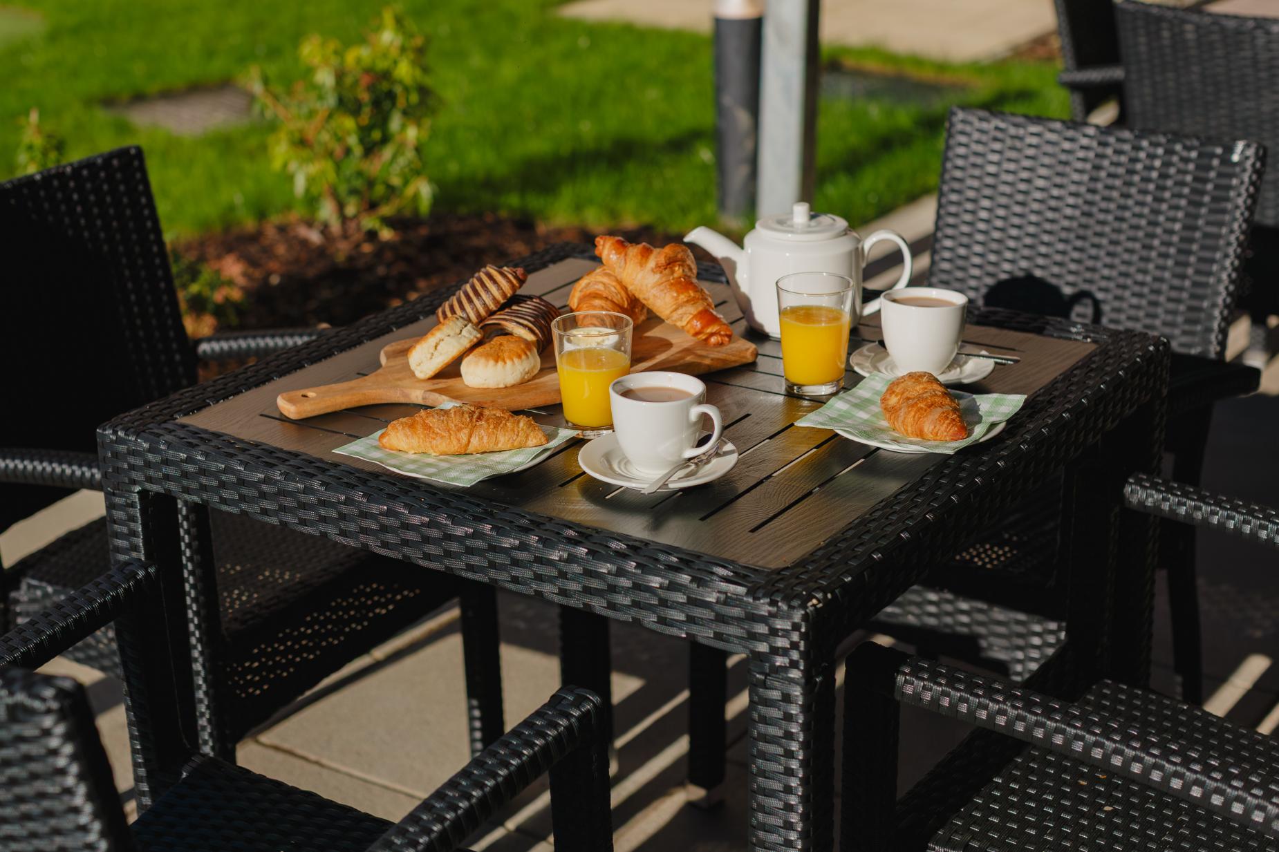 breakfast laid out on an outdoor patio table