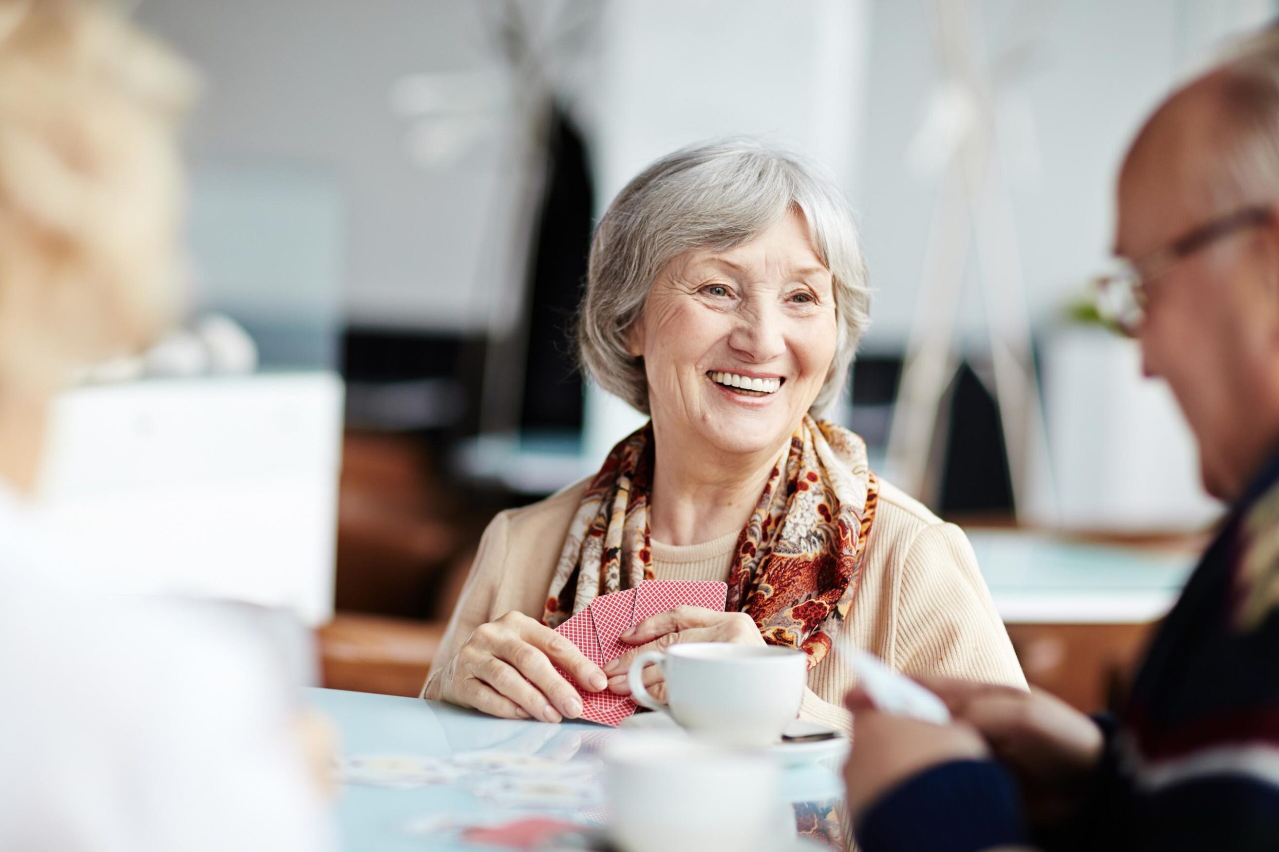elderly woman smiling in care home activity