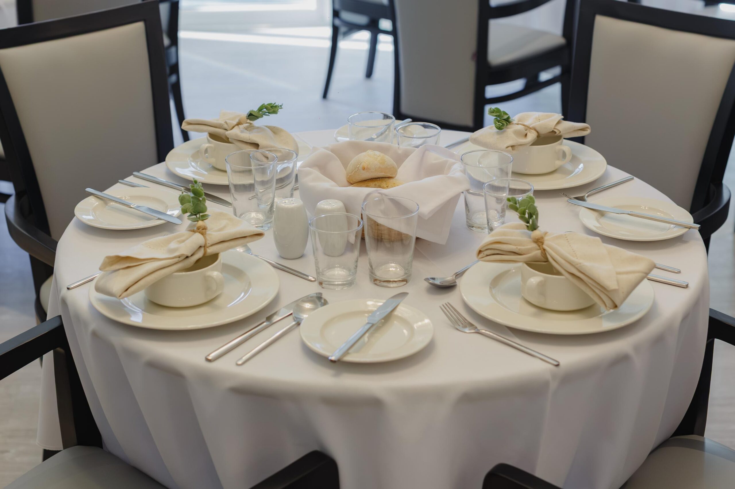 dining table set with plates, bowls and utensils